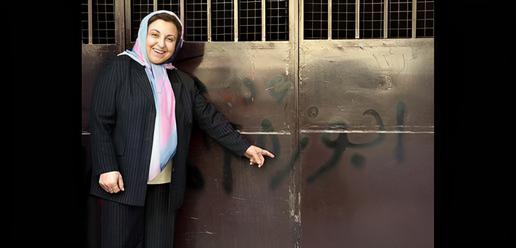 Shirin Ebadi pointing to an offensive graffiti sprayed on the door to her home in Tehran