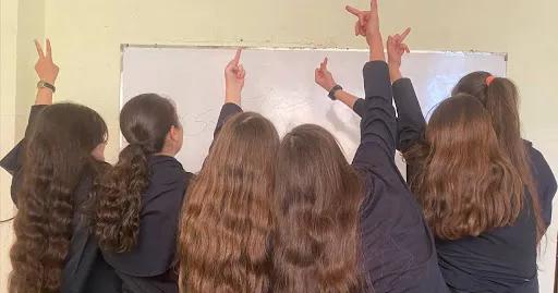Students at a girls' high school in Vali-e Asr neighborhood of this city were waving their scarves in the air while leaving the school chanting the slogan "Woman, Life, Freedom"