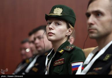 Photographs released by a semi-official Iranian media outlet of a Russian female military officer attending a public event without a head covering and wearing a short-sleeved shirt has triggered controversy inside Iran
