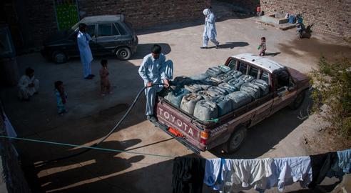 Typically, each vehicle transports around 2,000 liters of fuel, which is unloaded at the Pakistani border