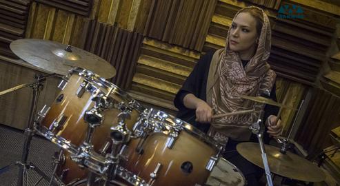 Young woman named Neda playing drums on January 12, 2017.