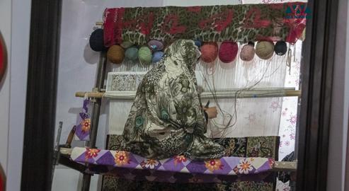 A woman weaving a carpet in her house on May 15, 2018. Carpets are among the main features of Iranian culture and art as well as one of Iran’s leading exports.