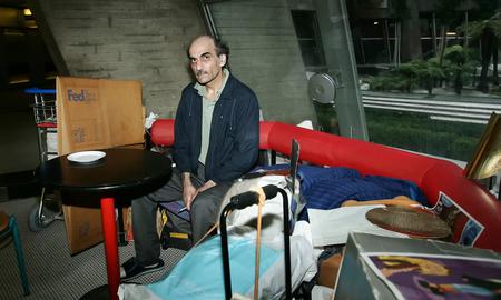 Mehran Karimi Nasseri, or ‘Sir Alfred’, on his home bench at Charles de Gaulle airport. Photograph: Eric Fougere/Corbis/Getty Images