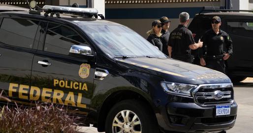 Brazilian officers standing at Federal Police headquarters