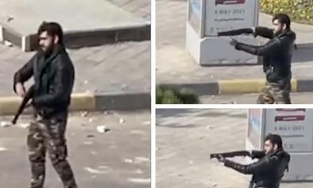 A Basij member shoots directly at protestors, October 2022