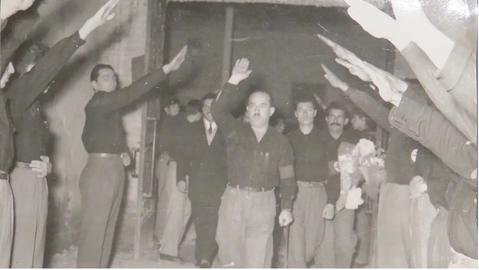 Davud Monshizadeh, founder and Rahbar of SUMKA, enters a crowd of saluting followers. Note the somewhat ostentatious crutch. Like SUMKA’s banner, the salute was claimed to have ancient Persian rather than Nazi German origins