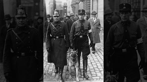 A police officer walks the streets of Berlin with an SS auxiliary policeman and his muzzled attack dog. Image Source: Bundesarchiv, Bild 102-14381