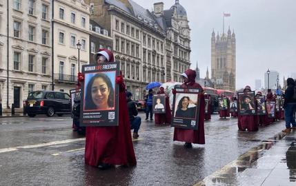 The protesters wearing the red cloaks and white bonnets imposed on female characters in the television series The Handmaid’s Tale marched from Parliament Square to the Iranian Embassy.