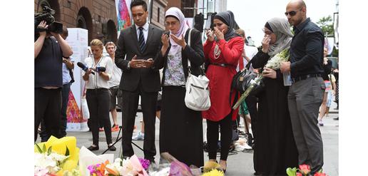 Muslims pray after laying flowers in Martin Place. 