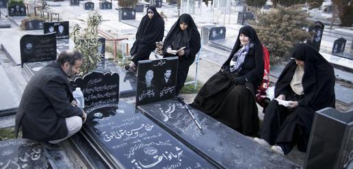 Family at the Behesht-e-Zahra cemetery, where soldiers who died during the Iran-Iraq war are buried. As a member of the ICC, Iran could lodge a case against future "crimes of aggression."
