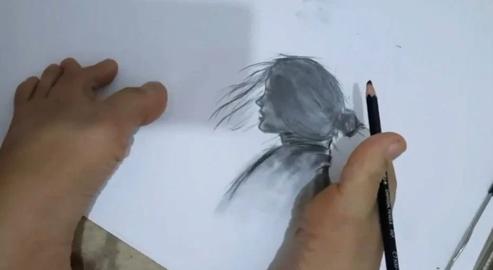 The IT technician does all her work for two organizations - and makes nightly charcoal drawings - using just one foot