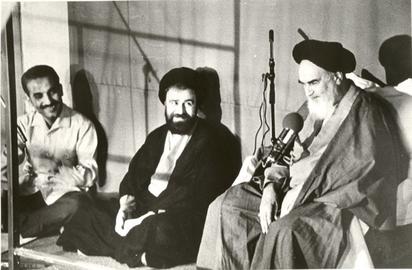 Rajai, left, enjoys a moment of levity with Ahmad Khomeini and his father