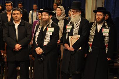 Witt is seen standing behind members of an anti-Israeli fringe Jewish group Neturei Karta in 2012