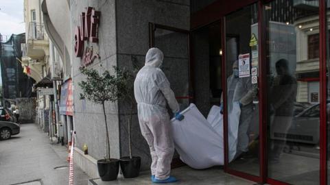 Mansouri's body being removed from the Duke Hotel in central Bucharest on June 19