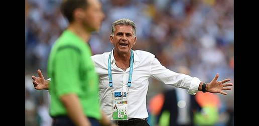 Queiroz objects to a referee decision during the Iran-Argentina game