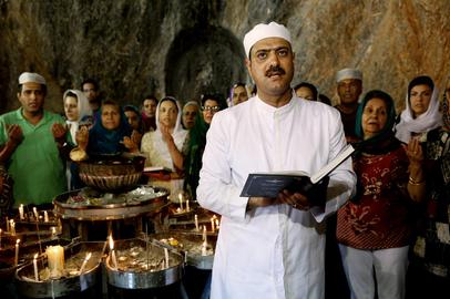 Zoroastrians praying in a temple dug into a mountainside