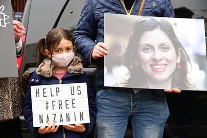Nazanin Zaghari-Ratcliffe's husband and daughter hold a vigil outside the Iranian Embassy in London in March 2021. Richard Ratcliffe has yet to receive confirmation of any deal made with Iran