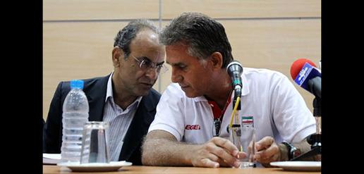 Carlos Queiroz signs his contract next to Ali Saeedlou, head of Iran’s Physical Education Organization