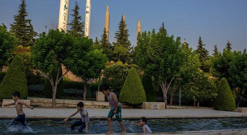 Kids play in the gardens of Tehran's Holy Defense Museum in front of the site's famous model missiles