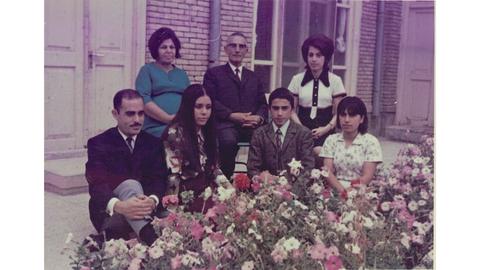 Parviz Firouzi with his family. He is seated in the middle of the back row