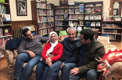 Separated by travel ban, Iranian families reunite at border library