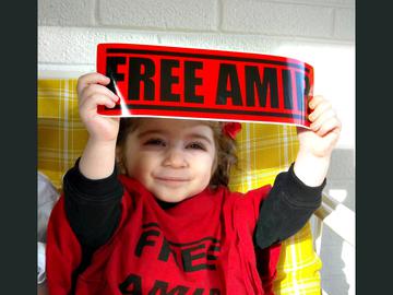 Amir's niece Maya holding a Free Amir sign