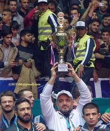 American team leader and Iranian liaison Hooman "Mo" Tavakolian proudly hoists the 2nd Place Trophy at the 2016 Wrestling World Clubs Cup in Iran