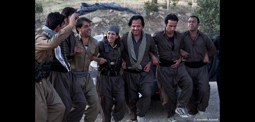A group of Peshmerga soldiers dance during a break from heavy military training in the camp.