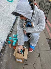 Greek muralist Argiris Ser works on his mural on Holywell Lane, Shoreditch, London
