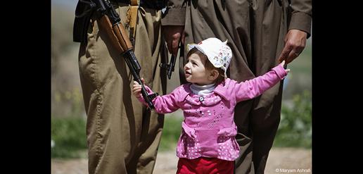 Eighteen-month-old Tavar is used to seeing her parents carry guns, like most other children who live in the camp.