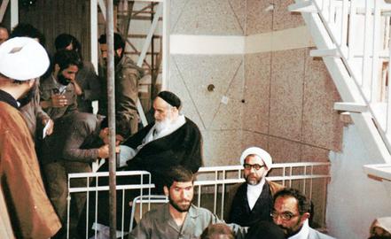 Ayatollah Khomeini, center, pictured at Evin Prison with Lajevardi kissing his hand, ordered the killings - latently recognized as genocide - in the final year before his death