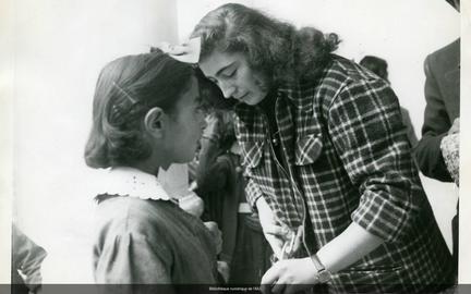 Clothing program. Colette Cuenca cutting fabric for girls‘ aprons in AIU’s school in Tehran, 1952. Courtesy of the Library of the AIU (Paris)