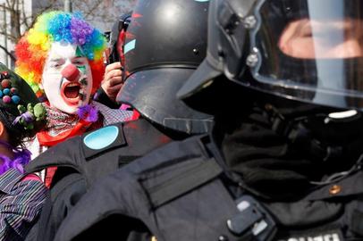 Clandestine Insurgent Rebel Clown Army teasing the German riot police, one of the roughest police forces in Europe