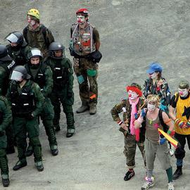 Clandestine Insurgent Rebel Clown Army teasing the German riot police, one of the roughest police forces in Europe